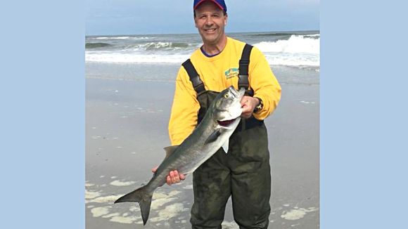 Rich Magas with a nice bluefish landed in the Brigantine surf. (Photo: RipTide Bait and Tackle, Brigantine NJ)