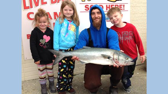 Noel Alago with his kids Alexander, Sierra, and Lacey helping to land this 10 pound bluefish. (Photo: RipTide Bait and Tackle, Brigantine NJ)