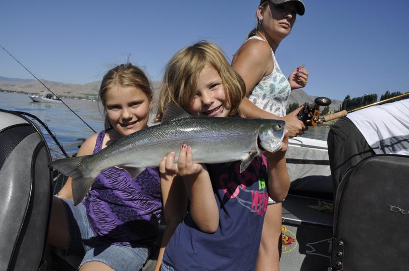Katlynn, 6, holds a sockeye caught by her sister Mckayla, 10, on a family fishing trip with their father, Omak guide Jerrod Gibbons on the Columbia River near Brewster on July 1, 2015. (Rich Landers)
