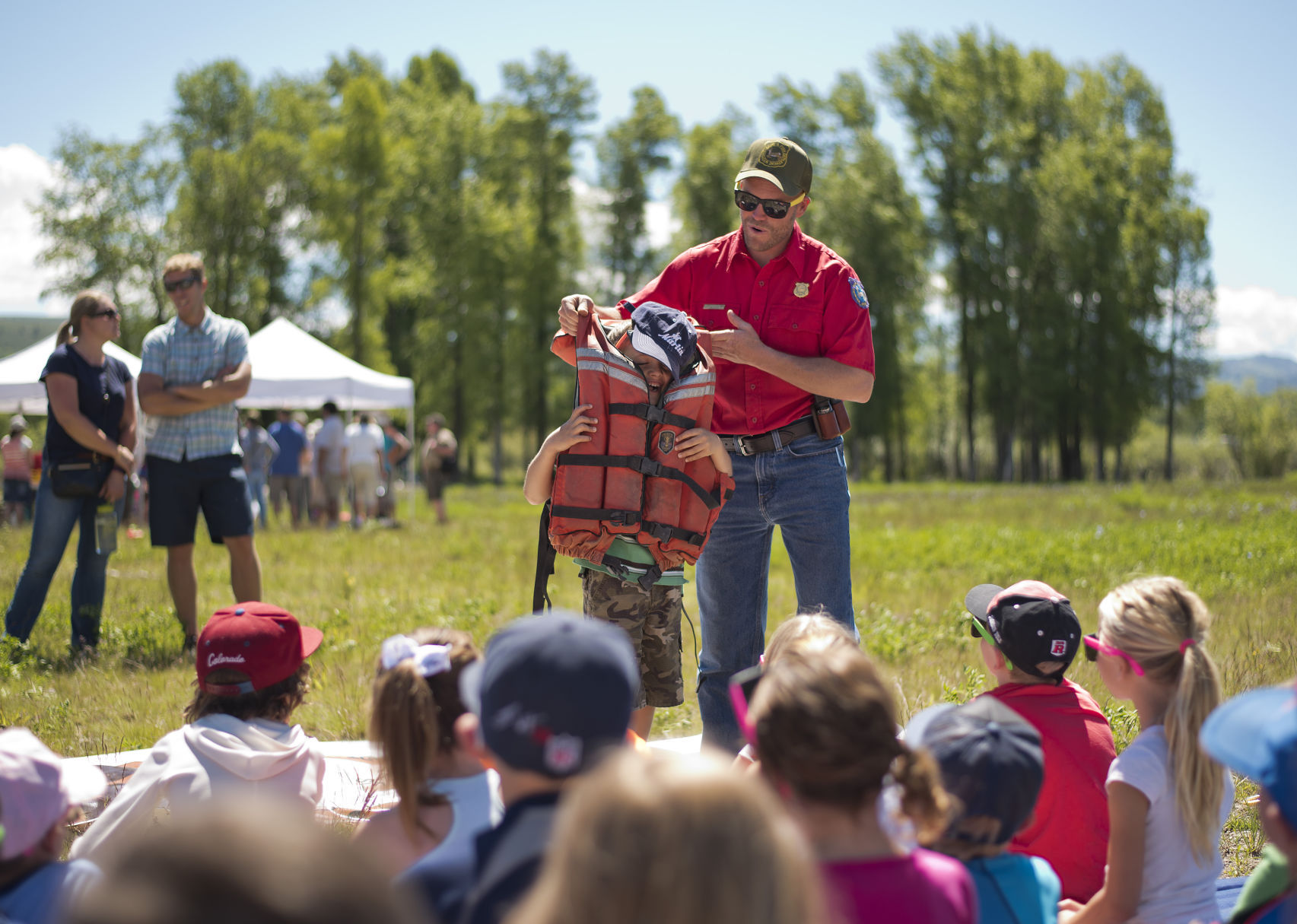 With volunteer Henry Yetter, 6, Wyoming Game and Fish warden Jon Stephens demonstrates what can happen when a life jacket is too loose.