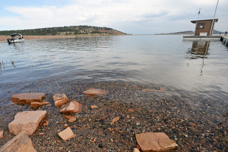 Water laps up on the shore of Carter Lake near the marina, April 10, 2015. 