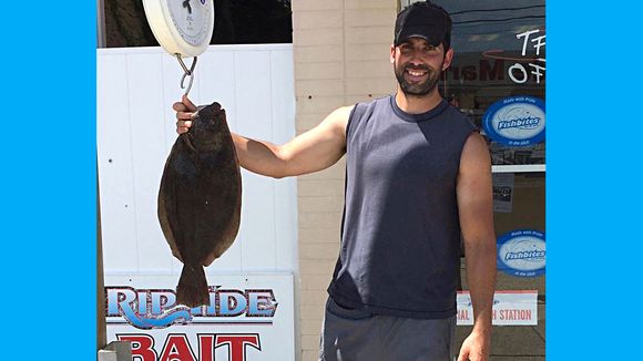 Jim Dinicola with a 6 pound flounder on the scale. (Photo: RipTide Bait and Tackle, Brigantine NJ)